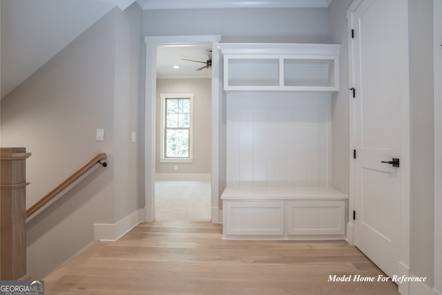 mudroom with light wood-style floors, a ceiling fan, and baseboards
