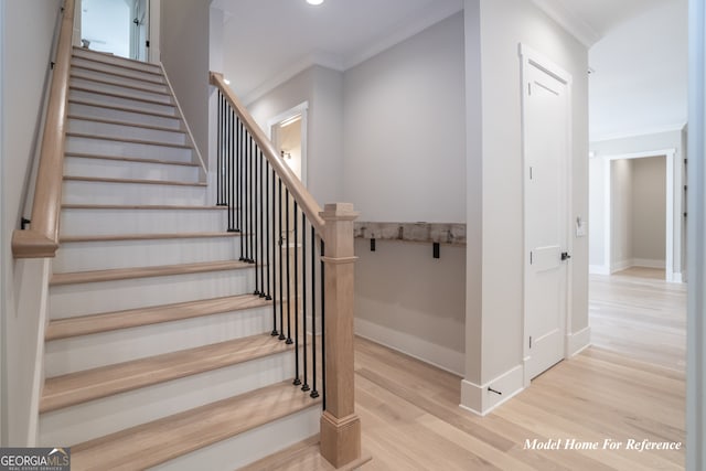 stairway featuring ornamental molding, wood finished floors, baseboards, and recessed lighting