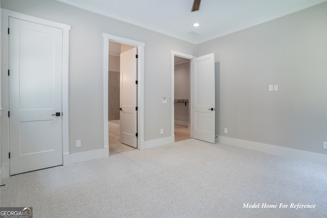 unfurnished bedroom with carpet flooring, crown molding, baseboards, recessed lighting, and ensuite bath