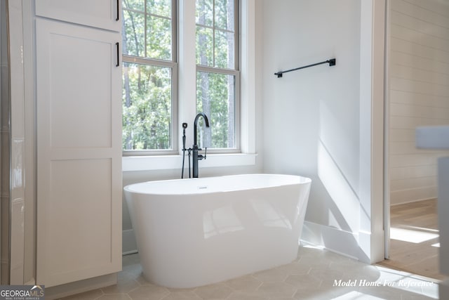full bath featuring a freestanding tub