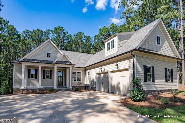 craftsman-style house with driveway, a porch, a shingled roof, and a garage