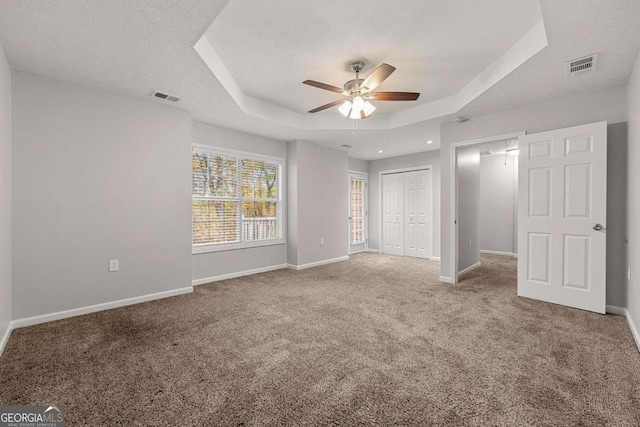 7165 Jonsway, Cumming, GA 30041 - unfurnished bedroom featuring a tray ceiling, carpet floors, baseboards, a closet, and a ceiling fan