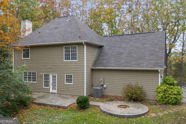 7165 Jonsway, Cumming, GA 30041 - back of house featuring a chimney, a patio, roof with shingles, central AC, and a yard