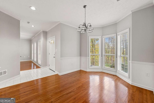 7165 Jonsway, Cumming, GA 30041 - unfurnished dining area with wood finished floors, a chandelier, crown molding, baseboards, and recessed lighting