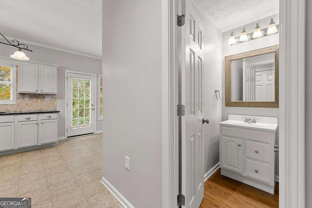 7165 Jonsway, Cumming, GA 30041 - bathroom with vanity, ornamental molding, decorative backsplash, and baseboards