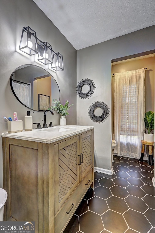 124 Laurel Dr, Barnesville, GA 30204 - bathroom featuring toilet, baseboards, and vanity