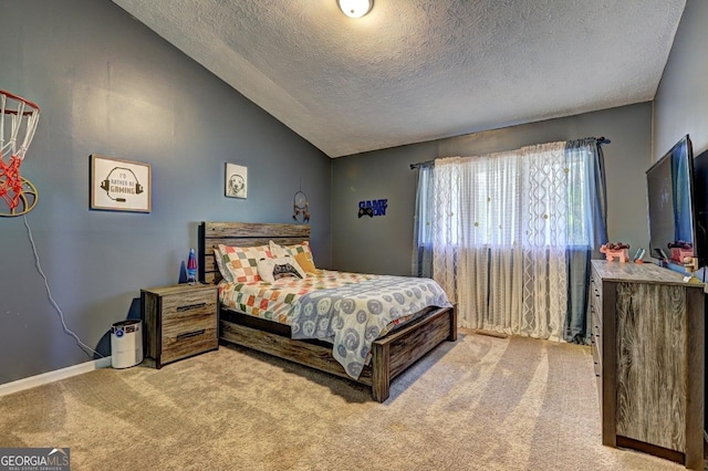 124 Laurel Dr, Barnesville, GA 30204 - bedroom featuring carpet floors, a textured ceiling, vaulted ceiling, and baseboards