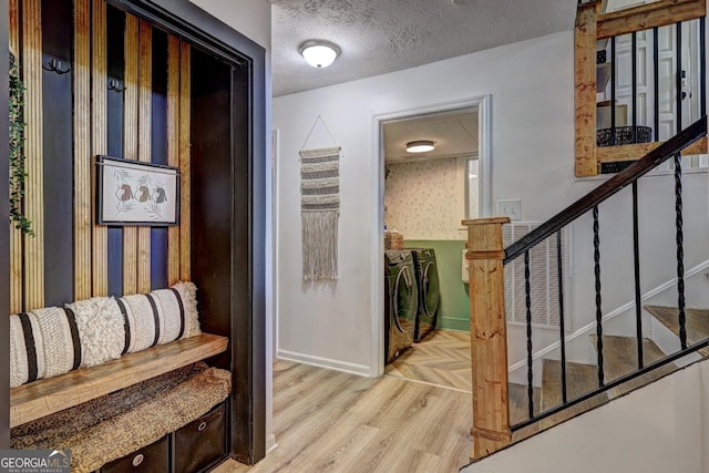 124 Laurel Dr, Barnesville, GA 30204 - hallway with washer and dryer, baseboards, parquet floors, stairway, and a textured ceiling