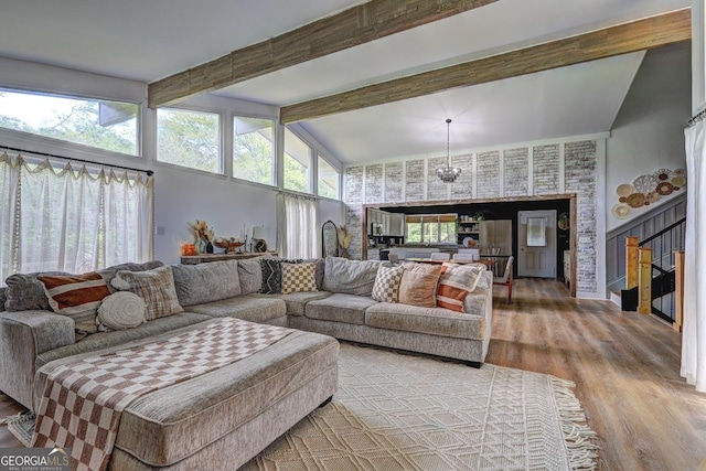 124 Laurel Dr, Barnesville, GA 30204 - living room featuring wood finished floors, beam ceiling, high vaulted ceiling, and stairway