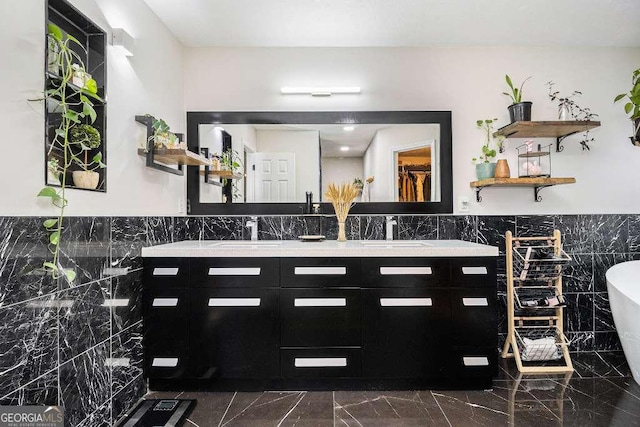 128 Graybrook Ct, Grayson, GA 30017 - full bathroom featuring tile walls, double vanity, a soaking tub, marble finish floors, and wainscoting