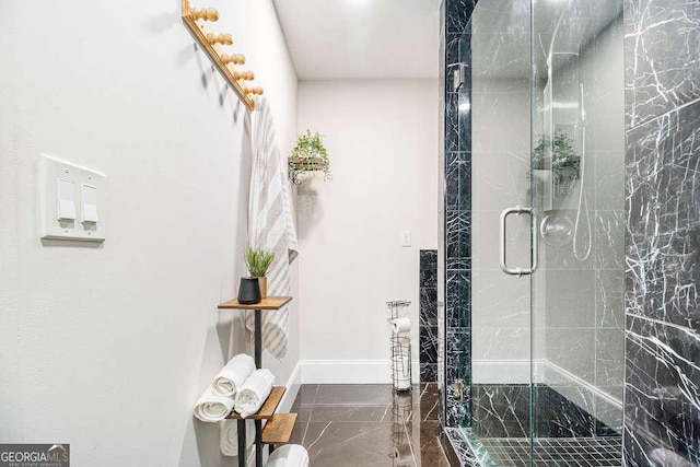 128 Graybrook Ct, Grayson, GA 30017 - bathroom with marble tiled floors, a shower stall, and baseboards