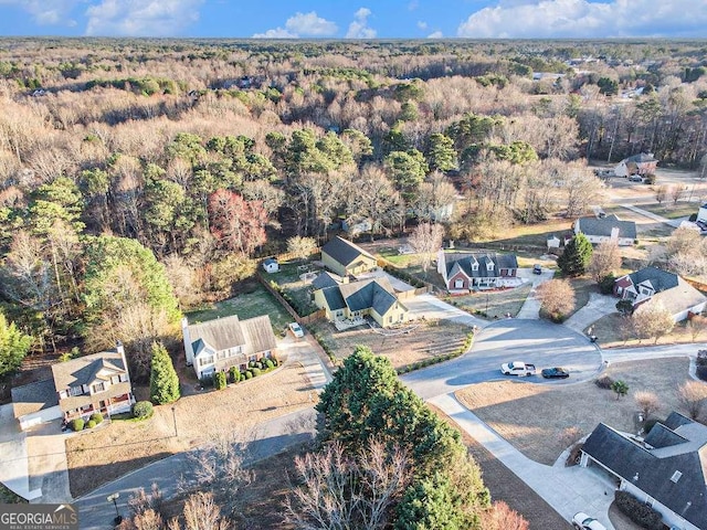 128 Graybrook Ct, Grayson, GA 30017 - aerial view of property and surrounding area featuring a heavily wooded area and nearby suburban area