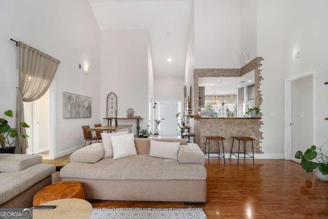 128 Graybrook Ct, Grayson, GA 30017 - living area with a towering ceiling, wood finished floors, and baseboards