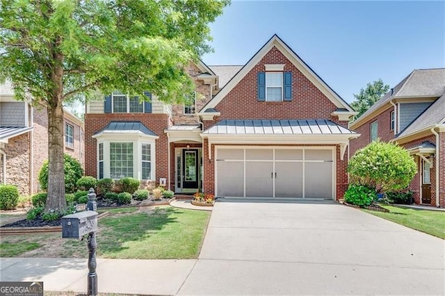 traditional-style house with a standing seam roof, driveway, brick siding, metal roof, and a garage