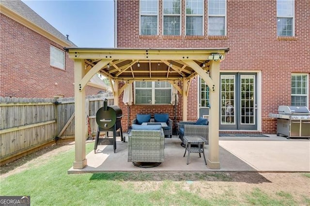 view of patio with a gazebo, a grill, a fenced backyard, and an outdoor living space