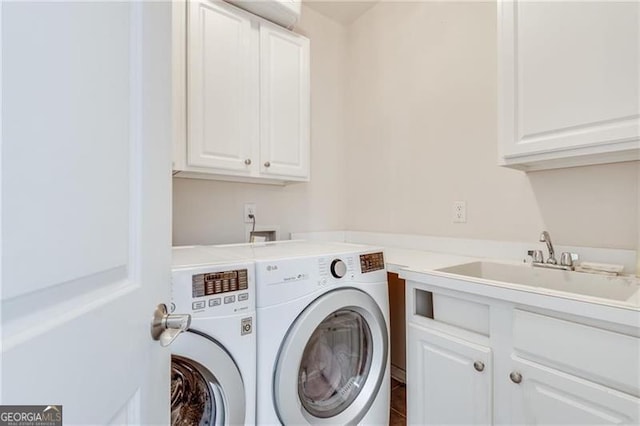 washroom featuring cabinet space and independent washer and dryer