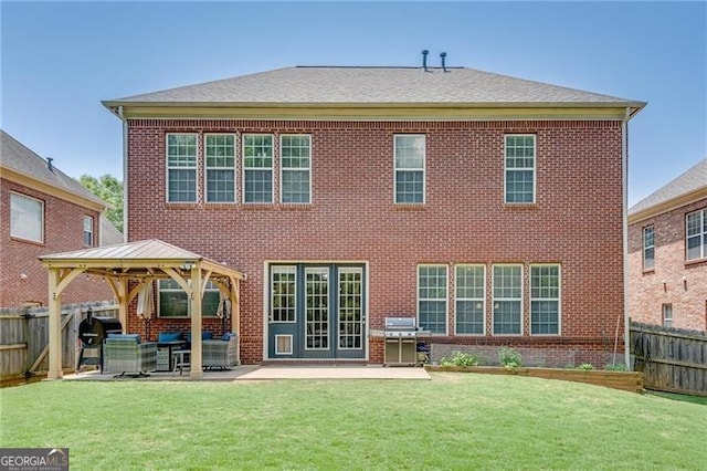 back of property with a gazebo, a patio, brick siding, and an outdoor living space