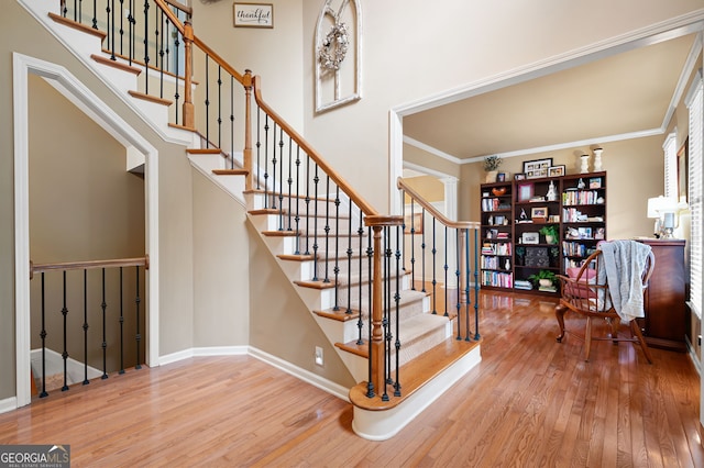 138 Knightwood Pt, Acworth, GA 30101 - stairs with wood-type flooring, baseboards, and crown molding