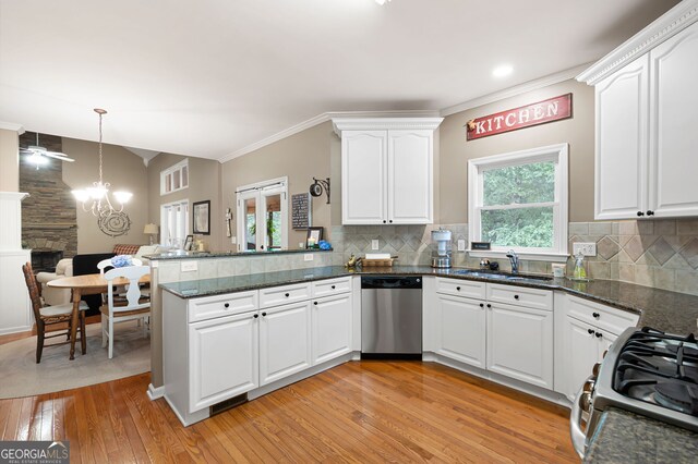 138 Knightwood Pt, Acworth, GA 30101 - kitchen featuring stainless steel appliances, a sink, a peninsula, white cabinetry, and tasteful backsplash
