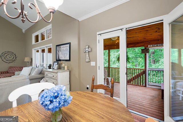 138 Knightwood Pt, Acworth, GA 30101 - dining area featuring crown molding, a chandelier, and vaulted ceiling