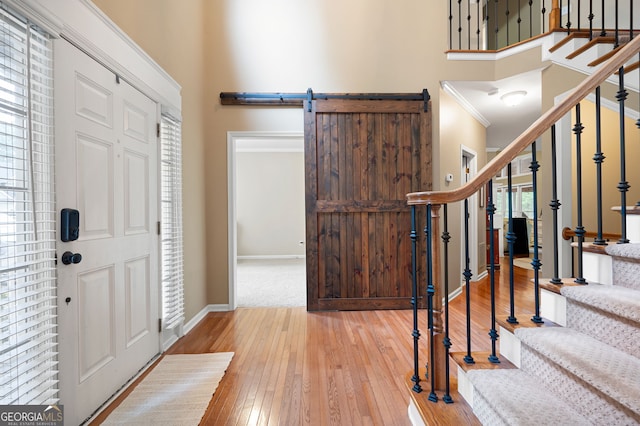 138 Knightwood Pt, Acworth, GA 30101 - foyer entrance featuring stairway, hardwood / wood-style flooring, baseboards, crown molding, and a towering ceiling