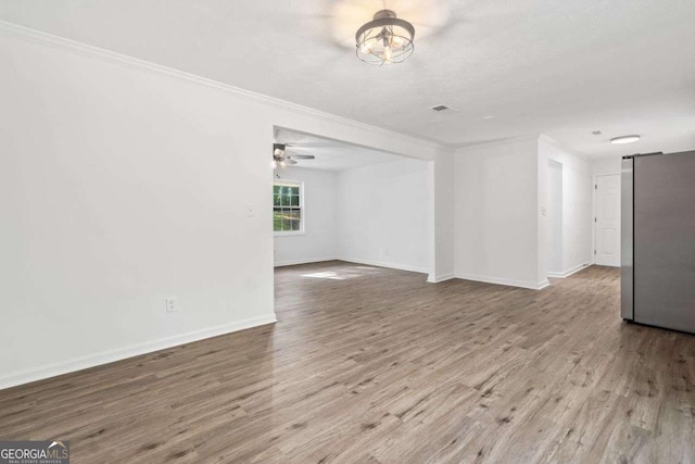 5155 Oakdale Ct, Douglasville, GA 30135 - unfurnished living room with ornamental molding, wood finished floors, baseboards, a barn door, and ceiling fan