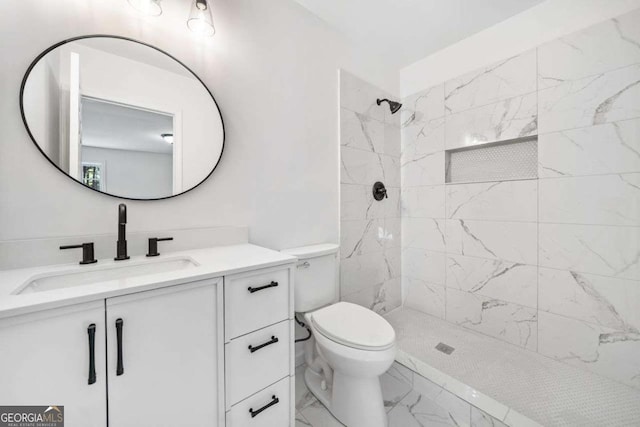 5155 Oakdale Ct, Douglasville, GA 30135 - bathroom with marble look tile flooring, a tile shower, vanity, and toilet