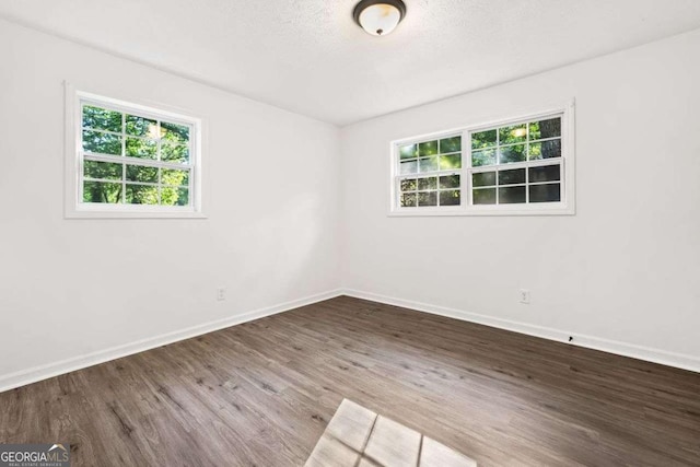 5155 Oakdale Ct, Douglasville, GA 30135 - unfurnished room featuring plenty of natural light, baseboards, and wood finished floors