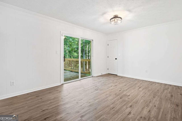 5155 Oakdale Ct, Douglasville, GA 30135 - unfurnished room featuring crown molding, wood finished floors, baseboards, and a textured ceiling
