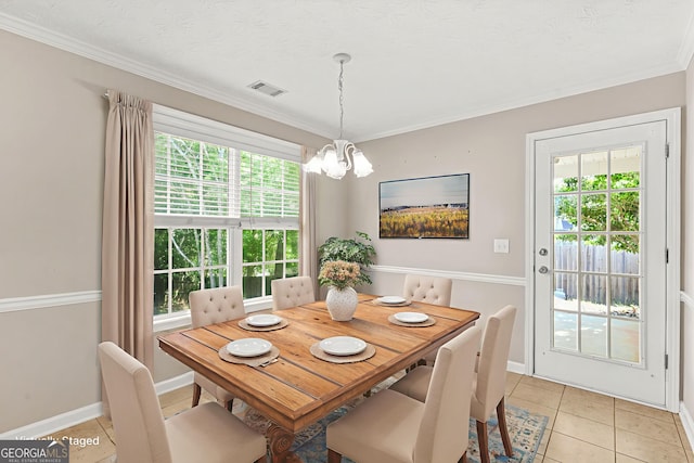 182 Garden Manor Ct, Loganville, GA 30052 - dining area with a chandelier, light tile patterned floors, and ornamental molding