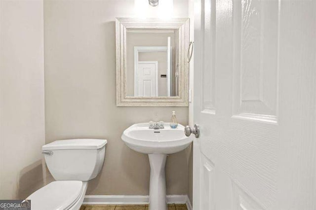 182 Garden Manor Ct, Loganville, GA 30052 - half bathroom featuring toilet and tile patterned flooring