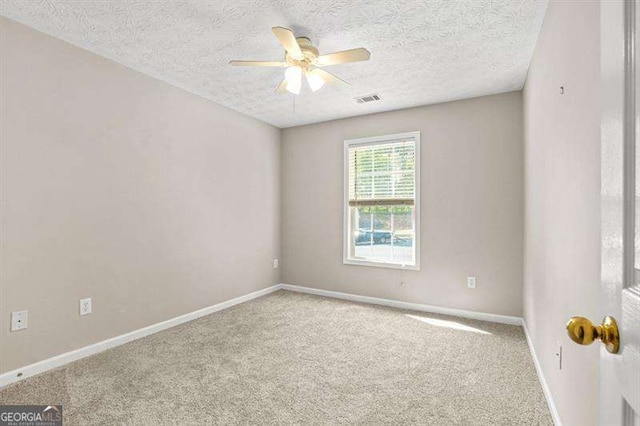 182 Garden Manor Ct, Loganville, GA 30052 - spare room with ceiling fan, carpet floors, and a textured ceiling