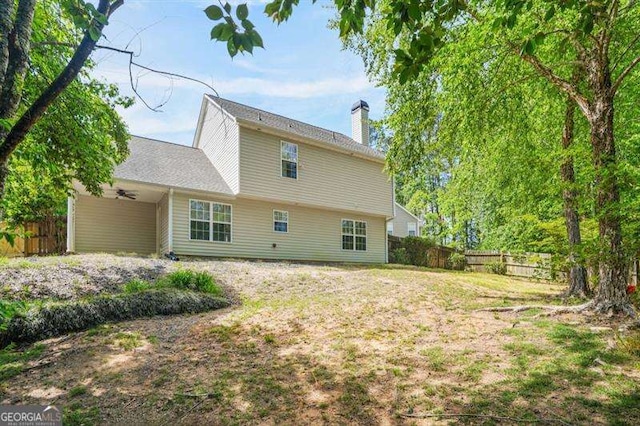 182 Garden Manor Ct, Loganville, GA 30052 - back of property with a ceiling fan and a chimney