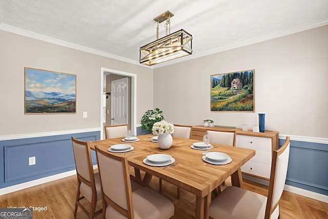 182 Garden Manor Ct, Loganville, GA 30052 - dining space featuring ornamental molding, a chandelier, and wainscoting
