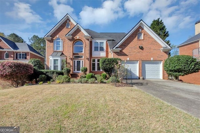 10890 Regal Frst, Suwanee, GA 30024 - traditional home featuring brick siding, a front lawn, driveway, and an attached garage
