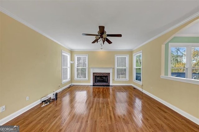 10890 Regal Frst, Suwanee, GA 30024 - unfurnished living room with wood finished floors, a ceiling fan, baseboards, a fireplace, and crown molding