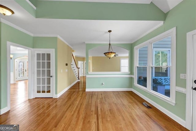 10890 Regal Frst, Suwanee, GA 30024 - unfurnished dining area with ornamental molding, wood finished floors, stairs, and baseboards