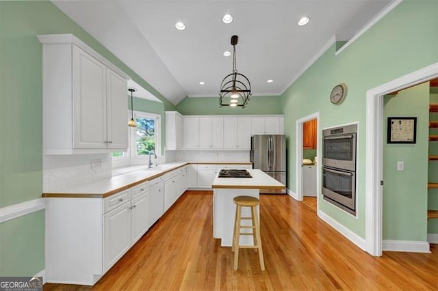 10890 Regal Frst, Suwanee, GA 30024 - kitchen featuring stainless steel appliances, white cabinetry, light countertops, ornamental molding, and recessed lighting