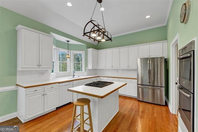 10890 Regal Frst, Suwanee, GA 30024 - kitchen with appliances with stainless steel finishes, decorative backsplash, white cabinetry, and recessed lighting