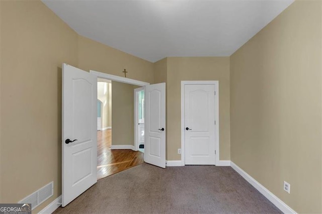 10890 Regal Frst, Suwanee, GA 30024 - unfurnished bedroom with carpet and baseboards