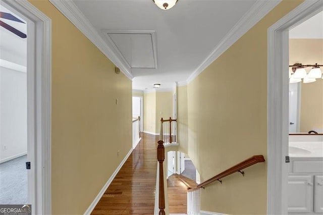 10890 Regal Frst, Suwanee, GA 30024 - hall featuring attic access, an upstairs landing, crown molding, wood finished floors, and baseboards
