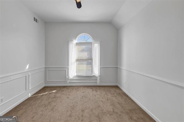 10890 Regal Frst, Suwanee, GA 30024 - carpeted empty room featuring lofted ceiling and a wainscoted wall