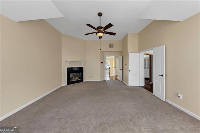 10890 Regal Frst, Suwanee, GA 30024 - unfurnished living room with a ceiling fan, carpet, baseboards, a glass covered fireplace, and high vaulted ceiling