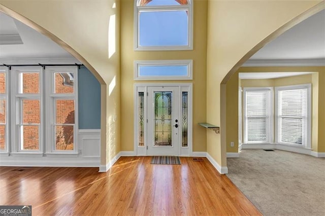 10890 Regal Frst, Suwanee, GA 30024 - foyer entrance with healthy amount of natural light, ornamental molding, wood finished floors, and baseboards
