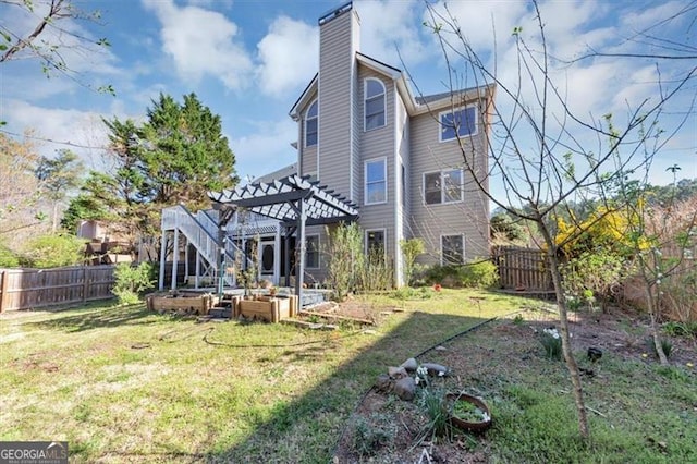 10890 Regal Frst, Suwanee, GA 30024 - back of property with a chimney, a pergola, and a vegetable garden