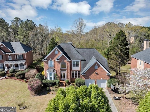 10890 Regal Frst, Suwanee, GA 30024 - view of front of property with a front lawn, an attached garage, and brick siding