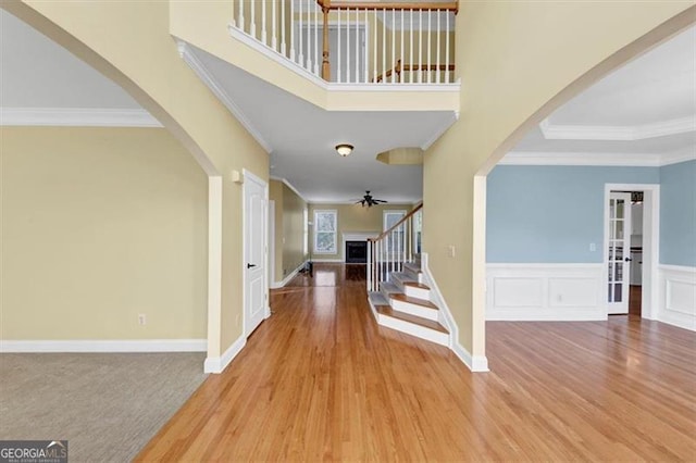 10890 Regal Frst, Suwanee, GA 30024 - foyer entrance featuring arched walkways, ornamental molding, ceiling fan, wood finished floors, and stairway