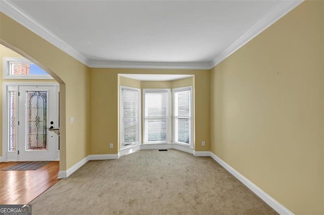 10890 Regal Frst, Suwanee, GA 30024 - unfurnished room with carpet floors, crown molding, arched walkways, and baseboards