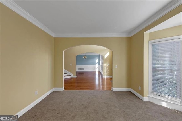 10890 Regal Frst, Suwanee, GA 30024 - empty room with arched walkways, ornamental molding, carpet flooring, baseboards, and stairs