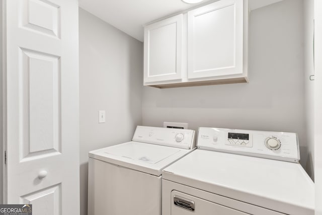 washroom with cabinet space and separate washer and dryer
